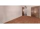 Simple carpeted bedroom with a closet, doorway and a large window that allows natural light at 501 E Hill Dr, Avondale, AZ 85323