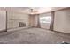 Spacious living room with a brick fireplace and large window providing ample natural light at 501 E Hill Dr, Avondale, AZ 85323