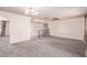 Open concept living space with ceiling fan, carpet, and metal railing to the right at 501 E Hill Dr, Avondale, AZ 85323