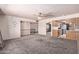 Open-concept living room with a ceiling fan, leading to the dining area and kitchen at 501 E Hill Dr, Avondale, AZ 85323