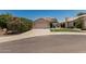 Charming single-story home features a two-car garage, manicured lawn, and beautiful flowering bushes at 51 N Rush St, Chandler, AZ 85226