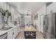 Stylish kitchen with white cabinetry, butcher block island, and direct view of the dining area at 51 N Rush St, Chandler, AZ 85226