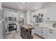 Well-lit kitchen featuring stainless steel appliances, light grey cabinets, and a view to the living room at 51 N Rush St, Chandler, AZ 85226