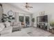 Comfortable living room with a sectional sofa, large windows, and modern entertainment center at 51 N Rush St, Chandler, AZ 85226