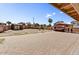 Large backyard with brick, a shaded structure, and additional structures at 5401 N 104Th Dr, Glendale, AZ 85307