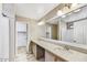 Bright bathroom with double sinks, modern vanity, and a large mirror over the countertop at 5401 N 104Th Dr, Glendale, AZ 85307