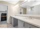 Bright bathroom with dual sinks, quartz countertop, gray vanity and walk in shower at 5401 N 104Th Dr, Glendale, AZ 85307