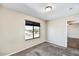Comfortable bedroom with neutral walls, soft carpet, and a window with neighborhood view at 5401 N 104Th Dr, Glendale, AZ 85307