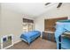 Bedroom features a twin bed, dresser, ceiling fan, carpet and exterior views at 5401 N 104Th Dr, Glendale, AZ 85307