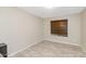 Empty room with tile floors, neutral paint, a ceiling light and exterior view at 5401 N 104Th Dr, Glendale, AZ 85307