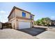 View of the two-story home featuring a two-car garage, desert landscaping, and a front brick patio at 5401 N 104Th Dr, Glendale, AZ 85307
