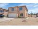 Front exterior featuring a two-car garage, low maintenance landscaping, and modern window design at 5401 N 104Th Dr, Glendale, AZ 85307