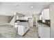 Open kitchen area with white cabinets, an island, granite countertops, and modern appliances at 5401 N 104Th Dr, Glendale, AZ 85307