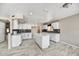 Spacious kitchen featuring white cabinets, granite countertops, an island, and sleek appliances at 5401 N 104Th Dr, Glendale, AZ 85307