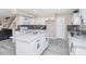 Modern kitchen with white cabinets, island with quartz countertops, and stainless steel appliances at 5401 N 104Th Dr, Glendale, AZ 85307