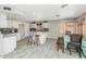 Bright kitchen featuring white cabinetry, tile backsplash, and dining area for casual meals at 5401 N 104Th Dr, Glendale, AZ 85307