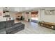 Open-concept living space boasts tile flooring, sliding glass door, and seamless flow to kitchen at 5401 N 104Th Dr, Glendale, AZ 85307