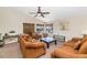 Inviting living room with vaulted ceiling, ceiling fan and plush brown furniture and window views to the exterior at 5401 N 104Th Dr, Glendale, AZ 85307