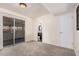Spacious bedroom features neutral carpet, ensuite bathroom, and glass sliding doors to a covered patio at 5415 E Butte St, Mesa, AZ 85205