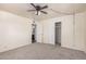 Neutral bedroom with ceiling fan, carpet, and closet access offers a relaxing space at 5415 E Butte St, Mesa, AZ 85205