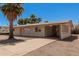 Quaint home featuring covered parking and mature trees for added curb appeal at 5415 E Butte St, Mesa, AZ 85205