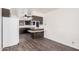 This kitchen has wood-look floors, a breakfast bar, and ample counter space for all your needs at 5415 E Butte St, Mesa, AZ 85205
