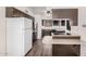 The kitchen features a breakfast bar, white refrigerator, and stainless steel wall oven and microwave at 5415 E Butte St, Mesa, AZ 85205