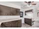 Bright kitchen has plenty of cabinets, an electric stovetop, and a breakfast bar with a laminate countertop at 5415 E Butte St, Mesa, AZ 85205