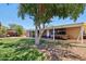 Inviting backyard with a covered patio, ideal for entertaining, with grass and shade tree at 5614 N 20Th Dr, Phoenix, AZ 85015