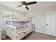 Light-filled bedroom featuring bunk beds, a ceiling fan, and neutral decor at 5614 N 20Th Dr, Phoenix, AZ 85015