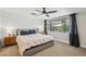 Comfortable primary bedroom featuring a large window, ceiling fan, and side tables at 5614 N 20Th Dr, Phoenix, AZ 85015