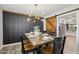 Dining area featuring black accent wall, modern light fixture, and wood table setting at 5614 N 20Th Dr, Phoenix, AZ 85015