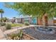 Charming single-story home featuring desert landscaping, mature trees, and a delightful front porch with seating at 5614 N 20Th Dr, Phoenix, AZ 85015