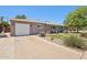 Charming single-story home featuring desert landscaping, an attached garage, and a delightful front porch with seating at 5614 N 20Th Dr, Phoenix, AZ 85015
