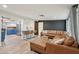 Open-concept living room with a spacious leather sectional, stylish bar seating, and modern decor at 5614 N 20Th Dr, Phoenix, AZ 85015