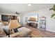Comfortable living room with wood floors, large sectional and mounted television at 5614 N 20Th Dr, Phoenix, AZ 85015