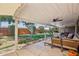 Outdoor patio with comfortable seating, a TV, and views of the landscaped backyard at 5614 N 20Th Dr, Phoenix, AZ 85015