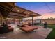 Backyard with pool, spa, built-in grill and covered patio at dusk at 6802 E Oak St, Scottsdale, AZ 85257
