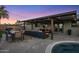 Covered patio with outdoor seating, a grill and dining area in a beautifully landscaped backyard at 6802 E Oak St, Scottsdale, AZ 85257