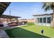Outdoor space with putting green, lounge area, and hot tub offers an entertainer's dream at 6802 E Oak St, Scottsdale, AZ 85257
