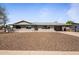 Charming single-story home with desert landscaping and attached carport on a sunny day at 6802 E Oak St, Scottsdale, AZ 85257