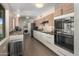 Open kitchen with stainless steel appliances and two-toned modern cabinetry at 6802 E Oak St, Scottsdale, AZ 85257