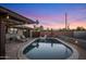 Backyard pool with patio, lounge chairs, and unique lighting in a private backyard with privacy fence at 6802 E Oak St, Scottsdale, AZ 85257