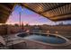 Backyard pool with patio, lounge chairs, unique lighting in a private backyard with privacy fence at 6802 E Oak St, Scottsdale, AZ 85257