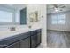 Bathroom featuring double sink vanity, tile floor, and view to bedroom at 7261 E Teal Way, San Tan Valley, AZ 85143