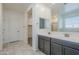 Bathroom featuring double sink vanity, walk-in closet, and tiled floors at 7261 E Teal Way, San Tan Valley, AZ 85143