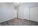 Neutral bedroom featuring modern vinyl floors and closet with sliding doors at 7261 E Teal Way, San Tan Valley, AZ 85143
