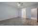 Bright bedroom features a ceiling fan, ensuite bathroom, and vinyl flooring at 7261 E Teal Way, San Tan Valley, AZ 85143