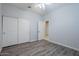 Bedroom with a closet, ceiling fan, vinyl floors, and a view into the next room at 7261 E Teal Way, San Tan Valley, AZ 85143