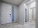 Clean entryway features grey walls, grey floors, and a bright white door and trim at 7261 E Teal Way, San Tan Valley, AZ 85143